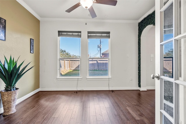 unfurnished room featuring dark hardwood / wood-style flooring, crown molding, and ceiling fan