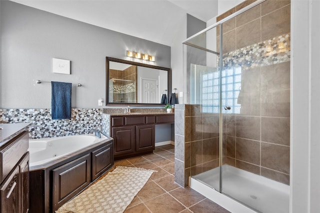 bathroom with independent shower and bath, vanity, and tile patterned flooring