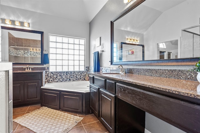 bathroom with lofted ceiling, vanity, tile patterned floors, and plus walk in shower