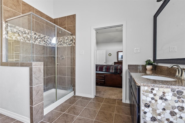 bathroom with vanity, an enclosed shower, and tile patterned floors