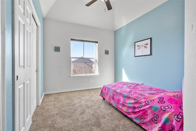 carpeted bedroom with lofted ceiling, ceiling fan, and a closet