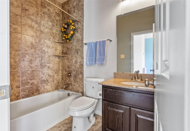 full bathroom featuring tiled shower / bath, vanity, and toilet