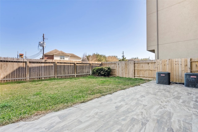 view of yard with central AC and a patio area