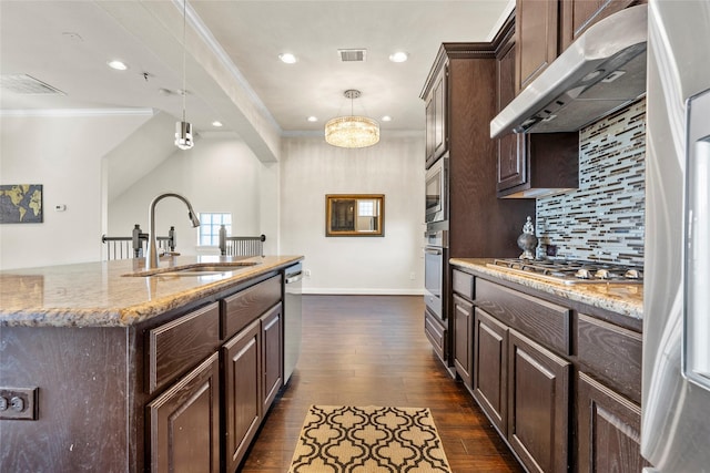 kitchen with sink, decorative light fixtures, dark brown cabinets, and appliances with stainless steel finishes