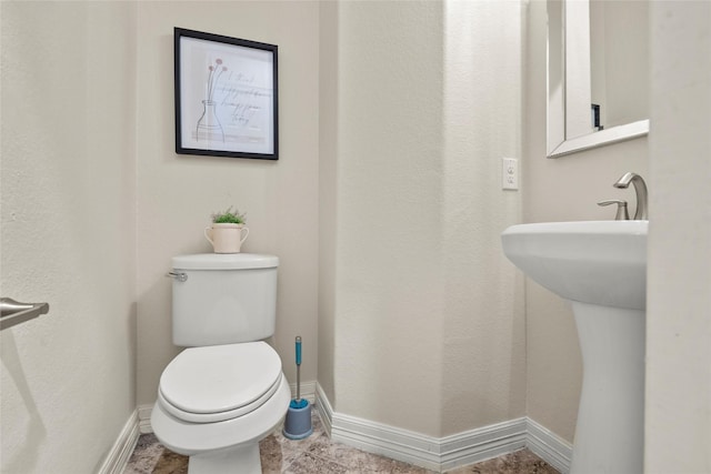 bathroom featuring sink and toilet