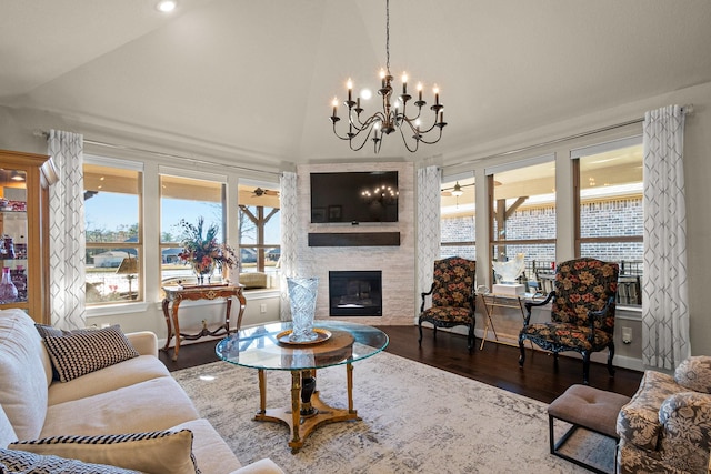 12169 Creekside Villas Ct, Conroe, TX 77304 - living area with a chandelier, vaulted ceiling, plenty of natural light, a fireplace, and wood finished floors