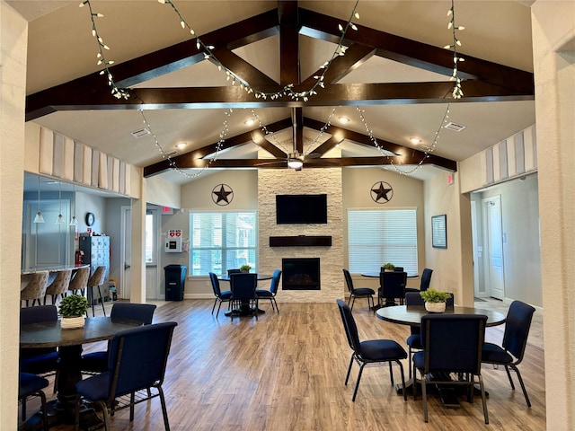 12169 Creekside Villas Ct, Conroe, TX 77304 - dining space with wood finished floors, a stone fireplace, and baseboards