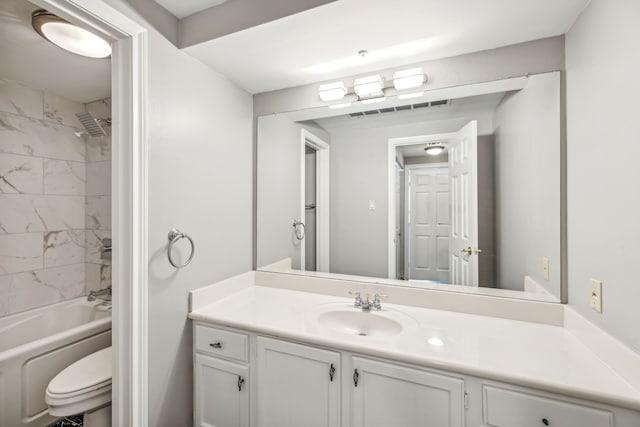 full bathroom with tiled shower / bath combo, vanity, and toilet