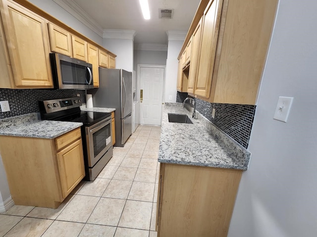 kitchen featuring light stone counters, ornamental molding, appliances with stainless steel finishes, and sink