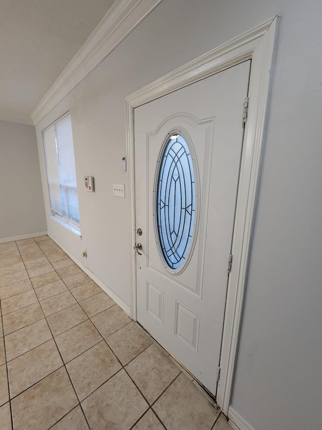 entryway featuring ornamental molding and light tile patterned floors