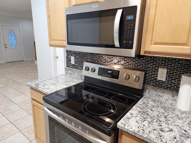 kitchen featuring light tile patterned flooring, appliances with stainless steel finishes, and light brown cabinets