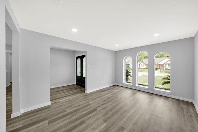 spare room with wood-type flooring