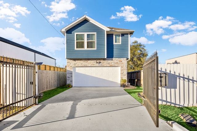 view of front of home featuring stone siding, an attached garage, concrete driveway, and fence