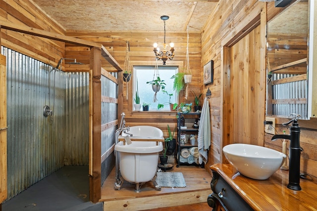 bathroom featuring wooden walls, a notable chandelier, and vanity