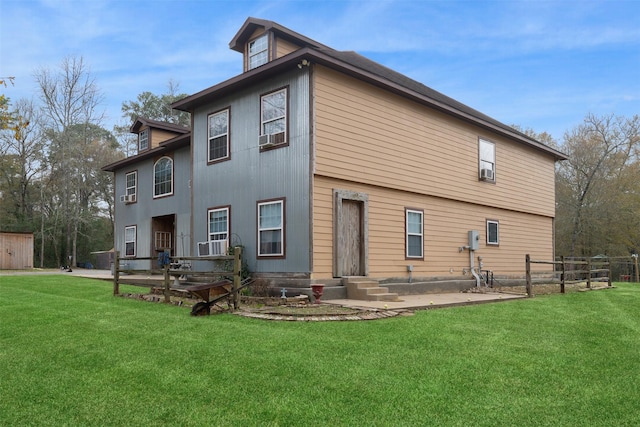 exterior space with entry steps, a lawn, and fence