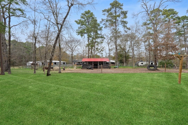 view of yard with driveway and fence