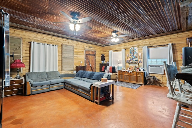 living area featuring concrete flooring, cooling unit, wooden walls, and a ceiling fan