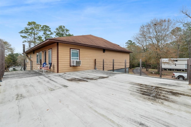 view of home's exterior with fence and cooling unit