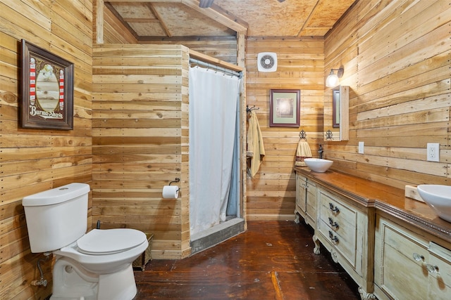 full bath with wood walls, toilet, and double vanity