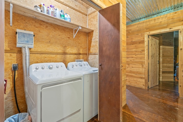 laundry room with wood walls and independent washer and dryer