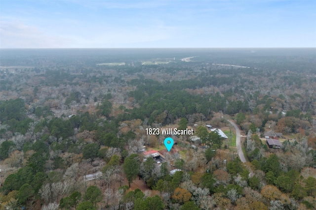 birds eye view of property with a view of trees