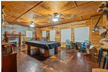 playroom with a fireplace, a ceiling fan, and pool table