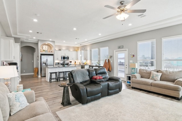 living room featuring ceiling fan and light hardwood / wood-style floors