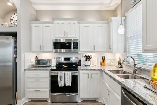 kitchen featuring white cabinetry, appliances with stainless steel finishes, and sink