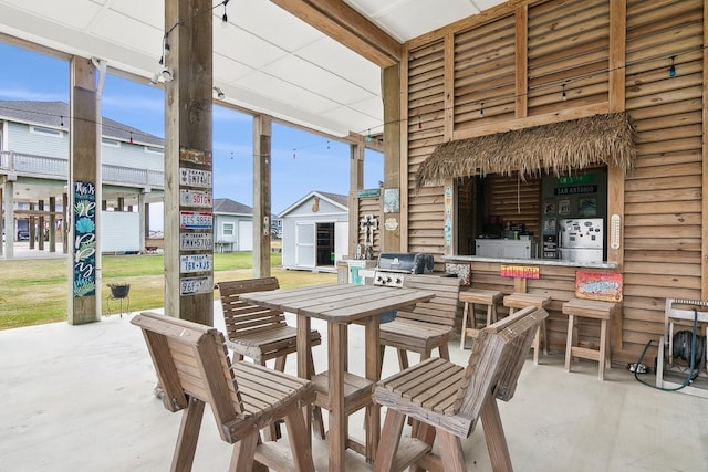 view of patio featuring a grill and exterior bar