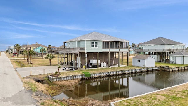 dock area featuring a water view and a patio