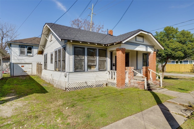 bungalow-style house featuring a porch and a front yard