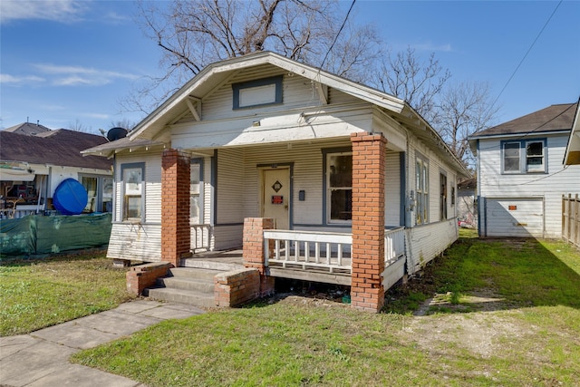 bungalow featuring a front lawn and a porch