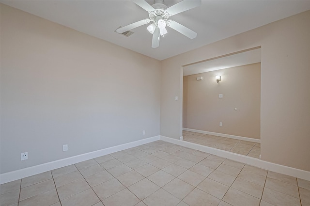 empty room featuring light tile patterned floors and ceiling fan