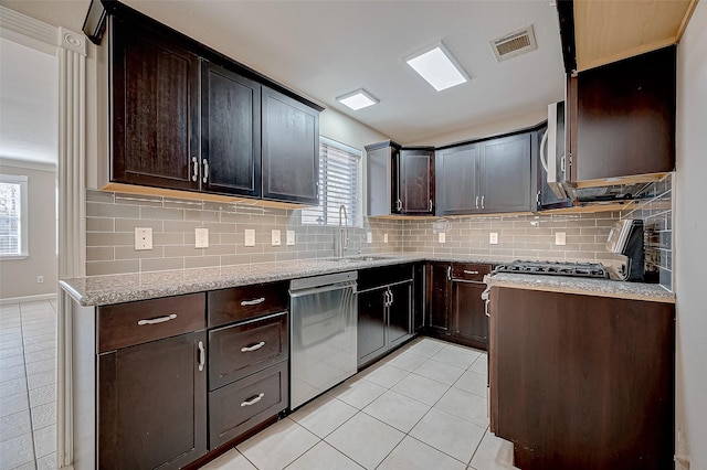 kitchen featuring appliances with stainless steel finishes, sink, and dark brown cabinets