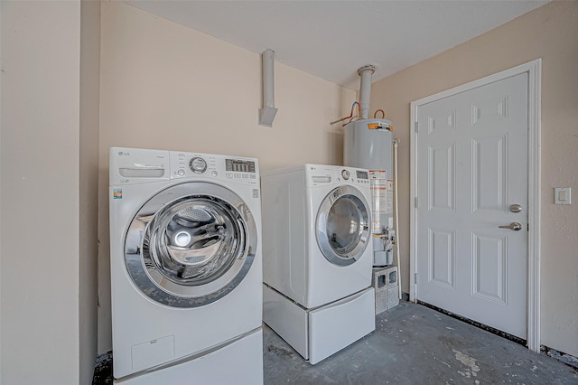 clothes washing area with water heater and washer and dryer