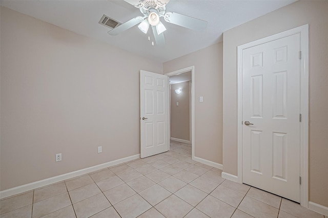 unfurnished bedroom featuring light tile patterned floors and ceiling fan