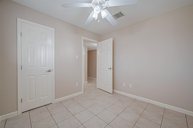 unfurnished bedroom with light tile patterned floors and ceiling fan