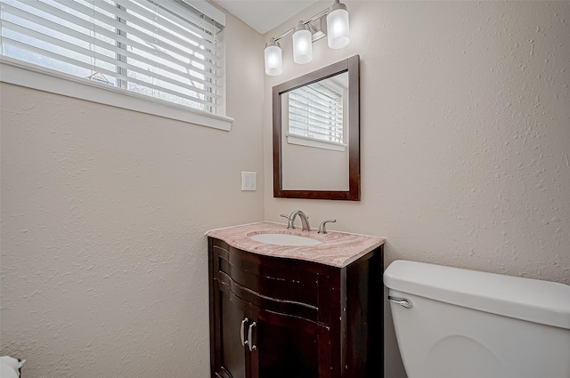 bathroom with vanity, plenty of natural light, and toilet