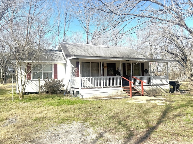 ranch-style house featuring a porch and a front yard