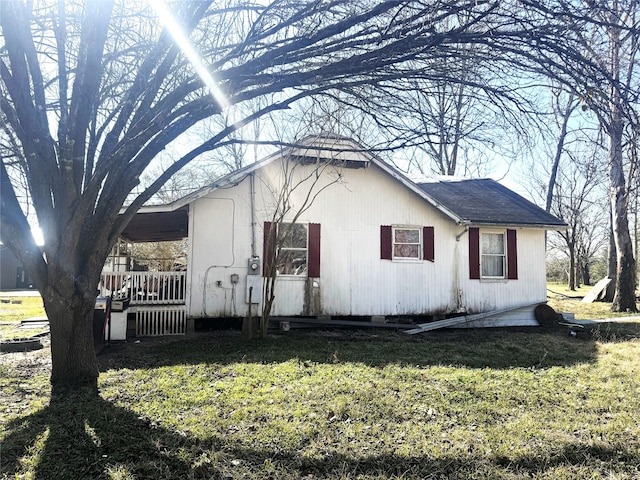 view of property exterior with a lawn