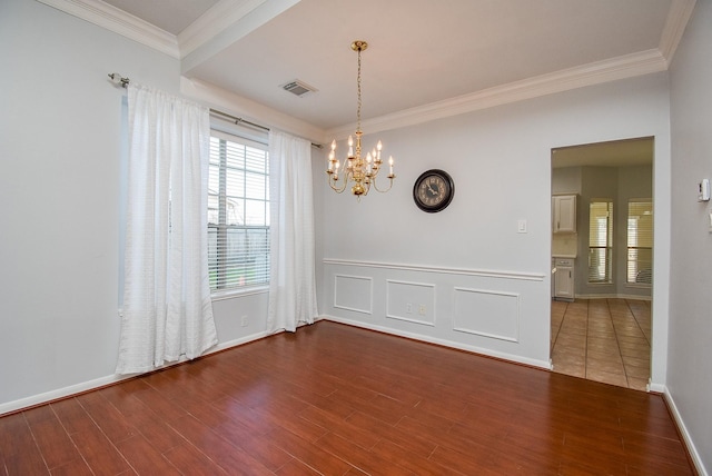 unfurnished room with crown molding, an inviting chandelier, and dark hardwood / wood-style flooring