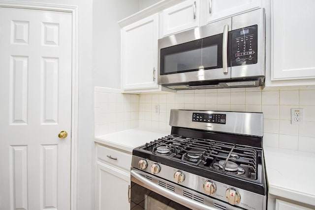 kitchen featuring appliances with stainless steel finishes and white cabinets