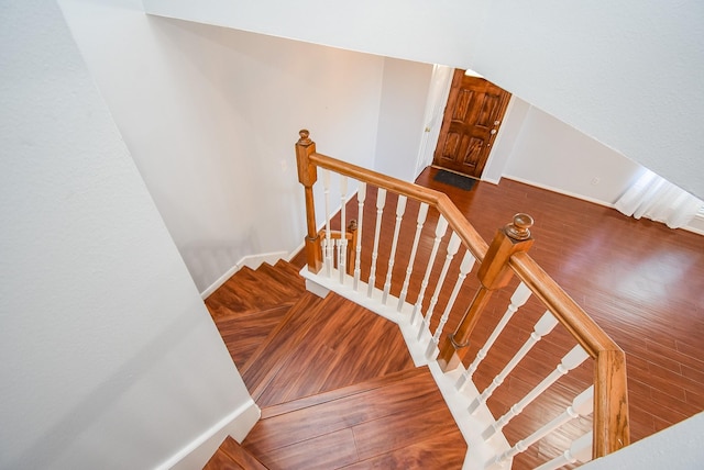 stairway with hardwood / wood-style flooring