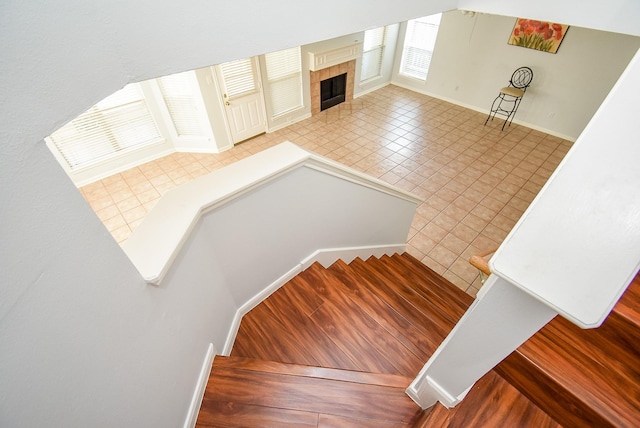 stairway with a tiled fireplace