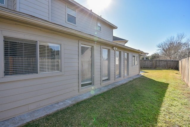 view of side of property with a yard