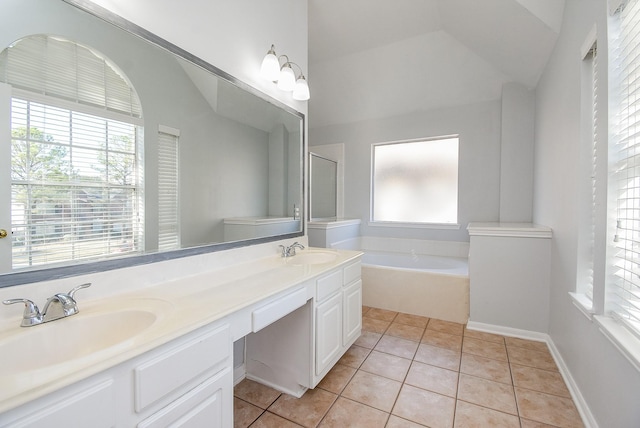 bathroom with a tub to relax in, tile patterned flooring, and vanity