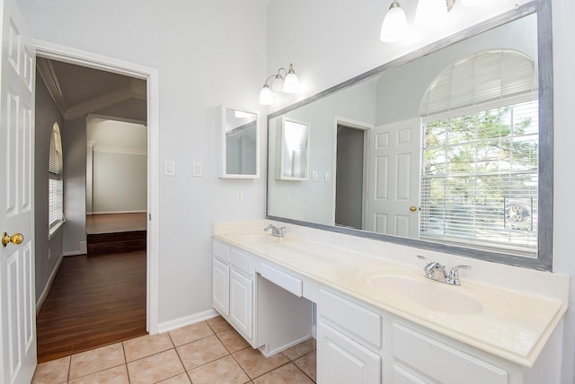 bathroom featuring ornamental molding, tile patterned floors, and vanity