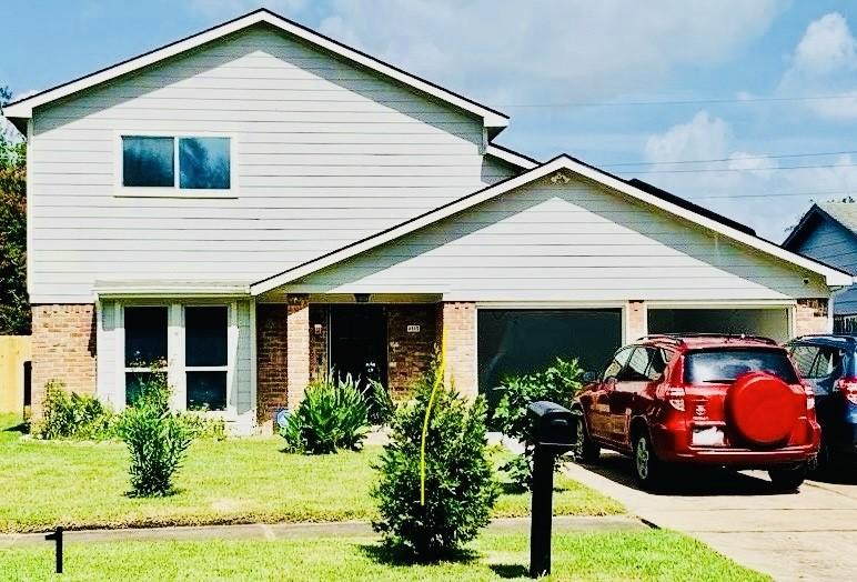 4115 Cedar Garden Dr, Houston, TX 77082 - view of front facade featuring a garage and a front lawn