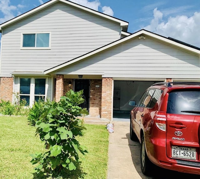 exterior space featuring a garage and a lawn