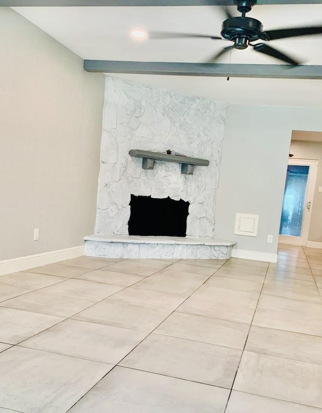 details with beamed ceiling, ceiling fan, and a stone fireplace